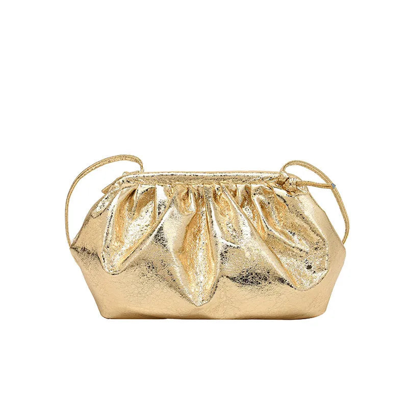 Rose red shell-shaped crossbody bag with magnetic hair clip closure and sewing line detail on the front.