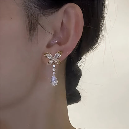 Pair of bow-shaped stud earrings with platinum electroplated finish on zinc alloy
