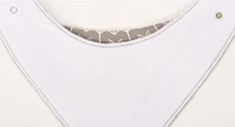 Set of four cotton baby bibs with arrow and wave designs for mess-free feeding