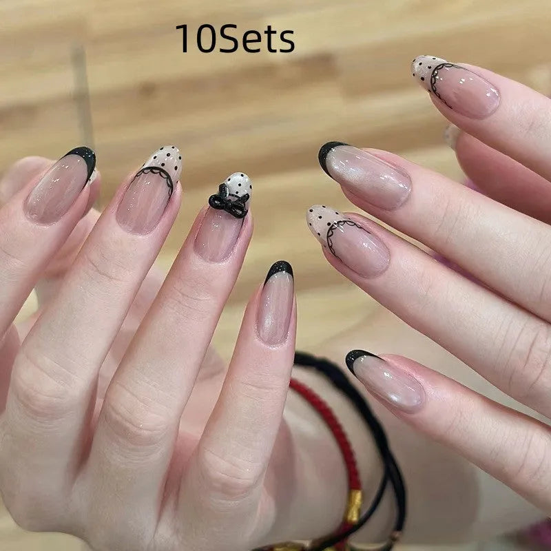 Five packs of reusable coloured false fingernails with various designs.