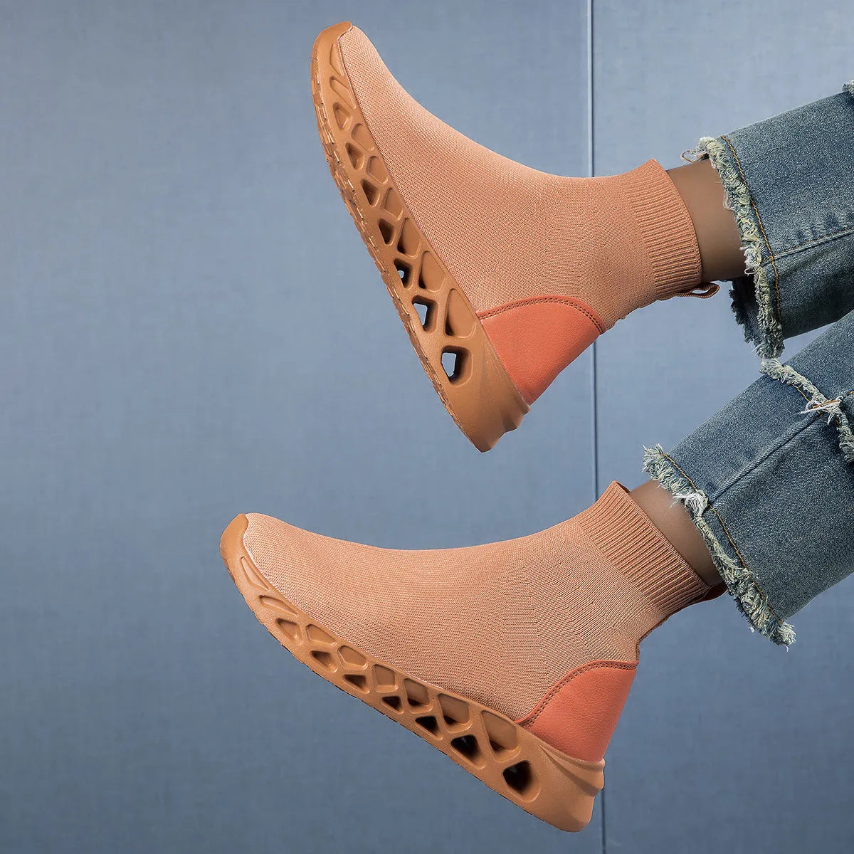 Women's casual mesh slip-on shoes in terracotta colour with flat sole and sewing line detail.