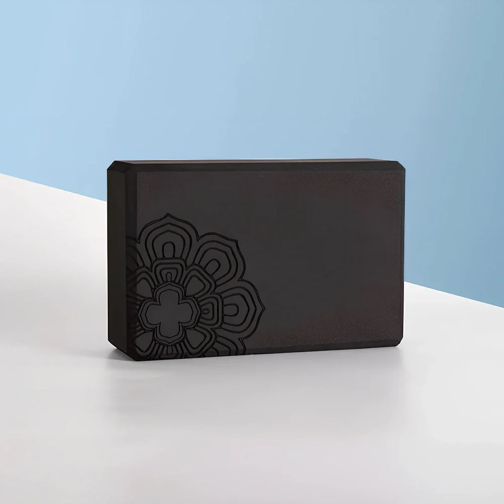 Black yoga brick with mandala pattern, 23cm long with textured surface for secure grip during yoga practice