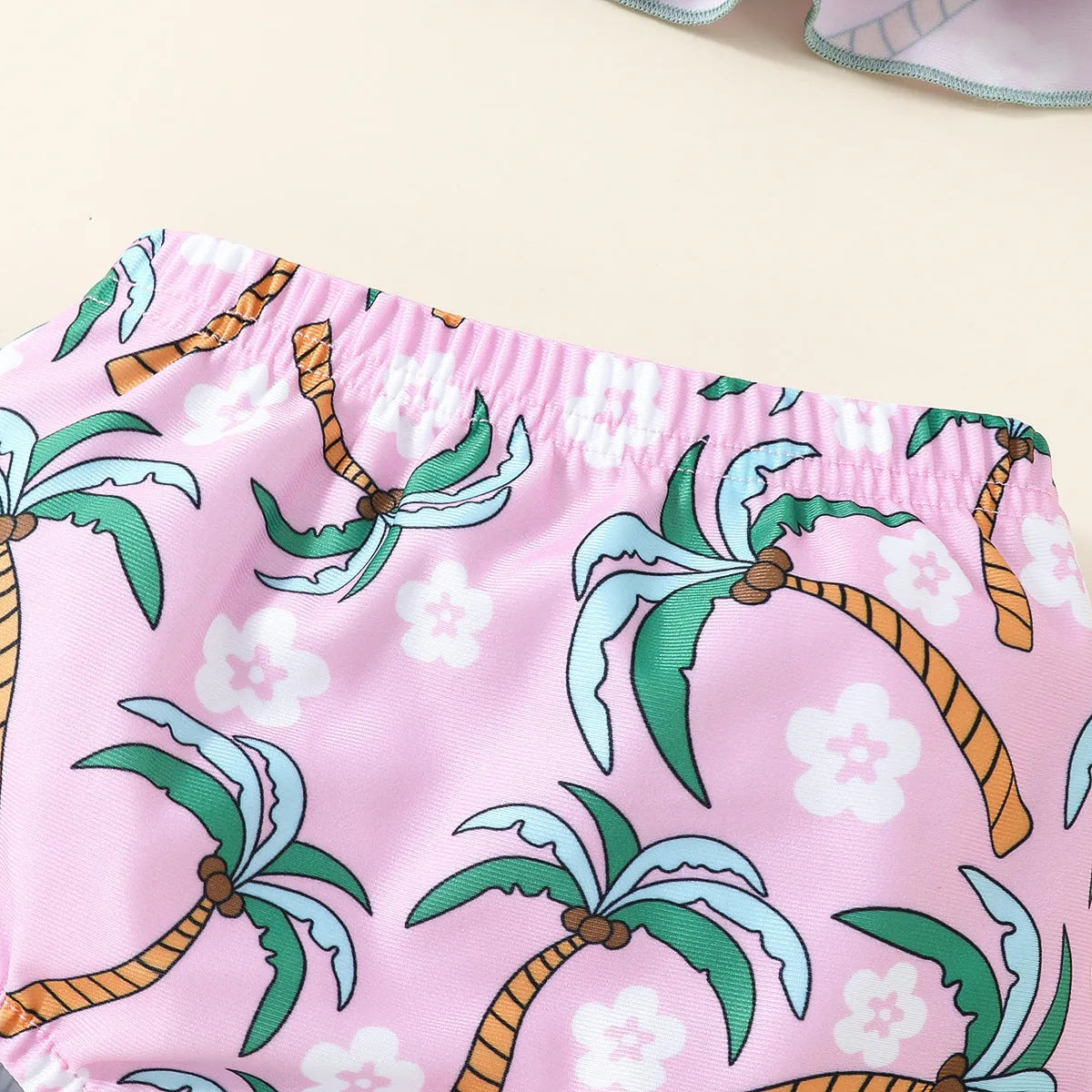 White polyester two-piece swimsuit set with top and shorts for a baby or toddler.
