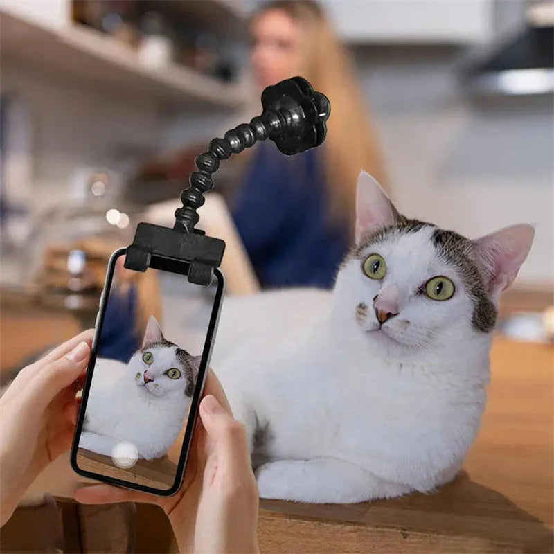 Multifunctional pet camera holder and selfie clip that securely attaches to your phone or mobile device and allows you to capture your furry friend's most playful moments with ease.