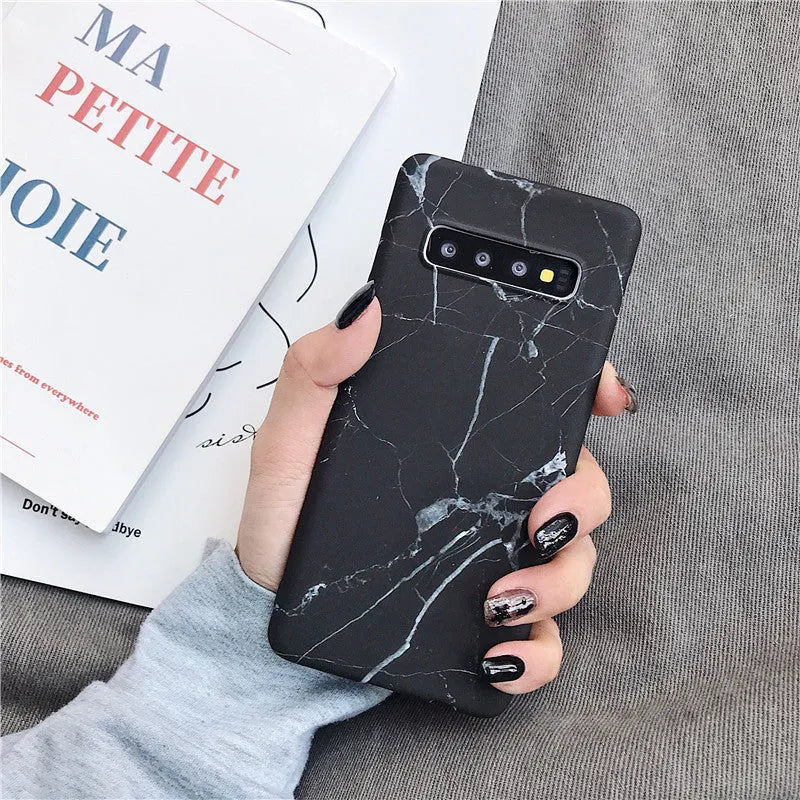 Samsung phone case with white and grey marble pattern on a polycarbonate back cover.