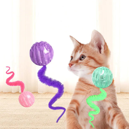 Green interactive cat toy with a bouncy ball and a long worm-shaped tail on a plain background.