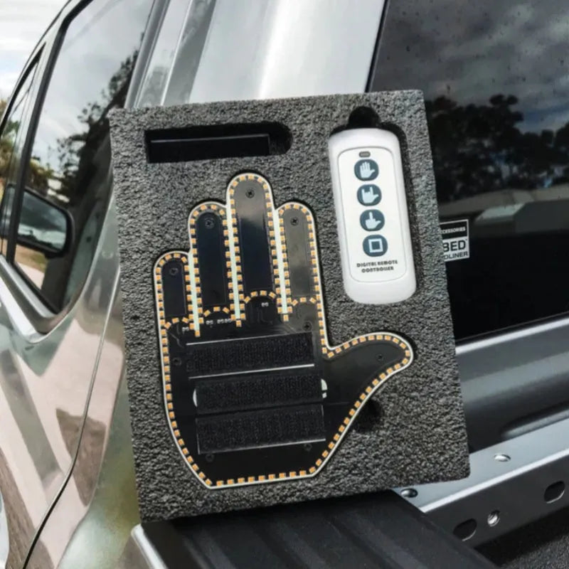 Black plastic LED gesture car light showing illuminated hand symbol, with remote control.
