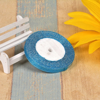 Close-up of green onion patterned ribbon with gold wire on a 25-yard roll, showing 3-points width.