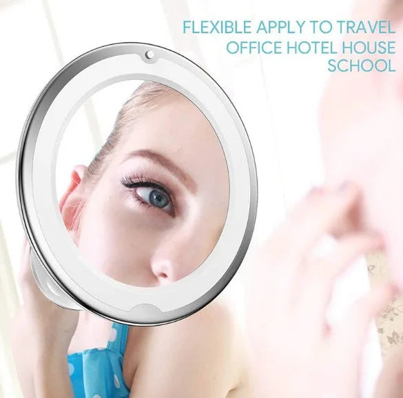 White 10x magnifying LED makeup mirror with flexible gooseneck and suction cup base on a table.