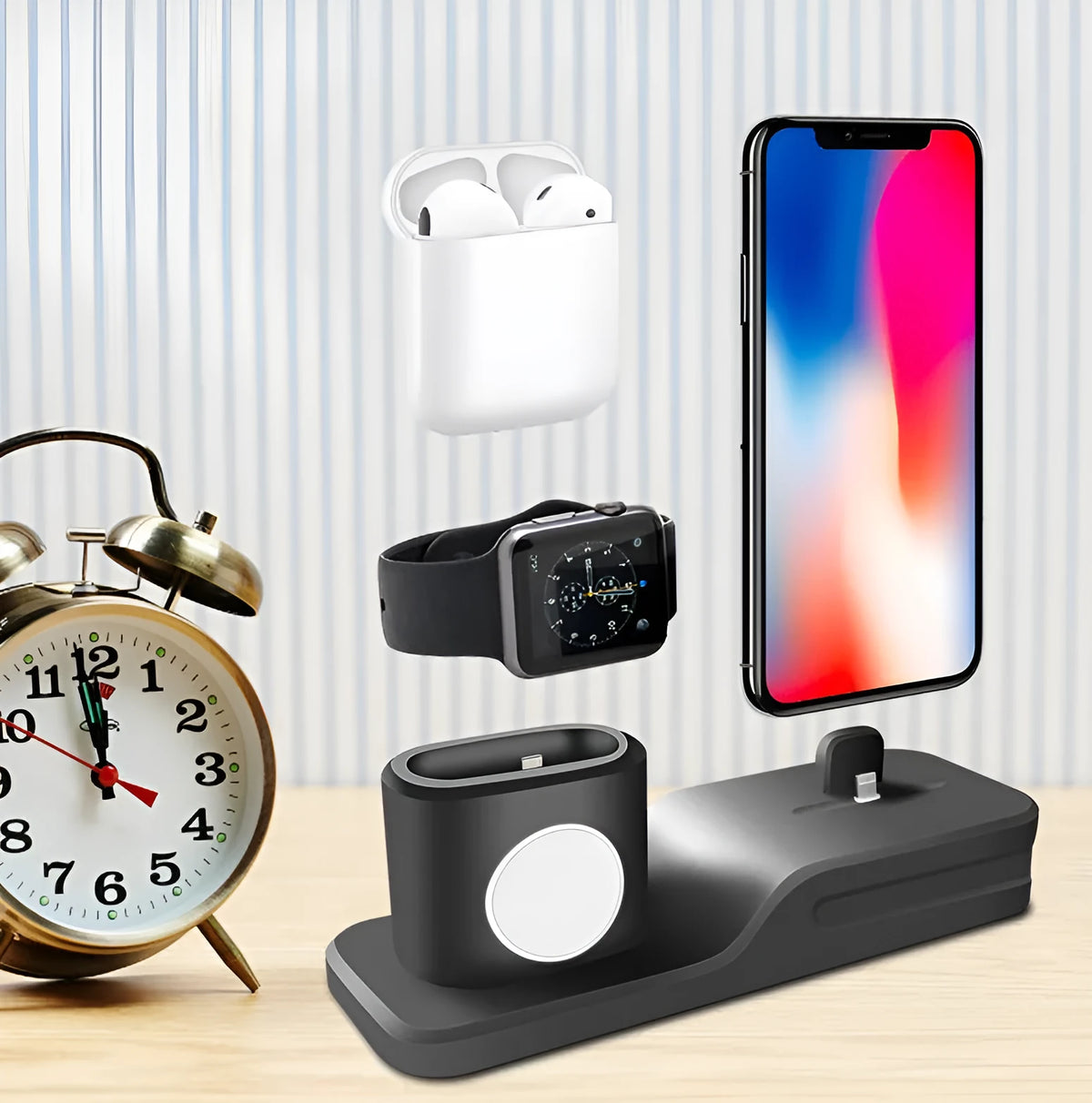 Black silicone 3-in-1 charging stand for Apple iPhone, Apple Watch, and AirPods on a desk