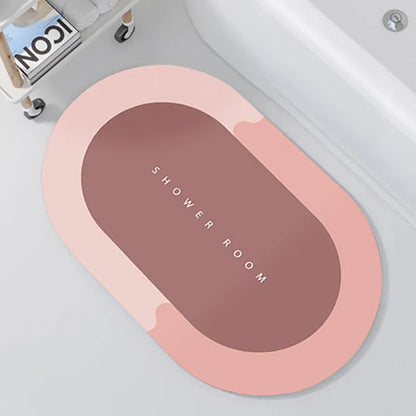 Oval diatomite bathroom floor mat in blue with natural rubber non-slip backing on tiled floor.