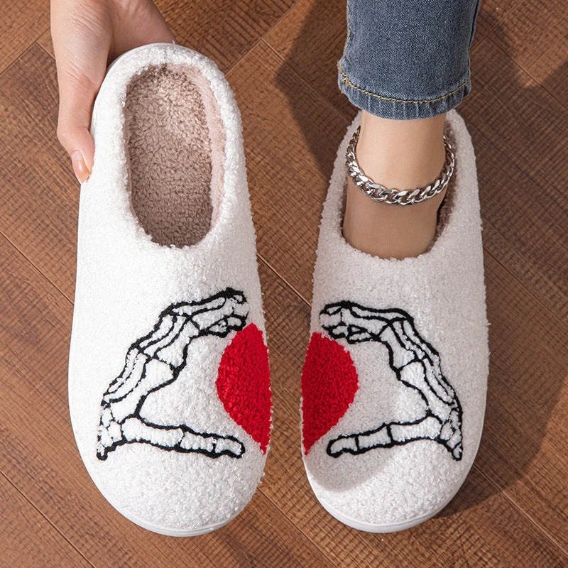Halloween-themed skull-hand slippers in black and white, featuring non-slip soles for indoor comfort.