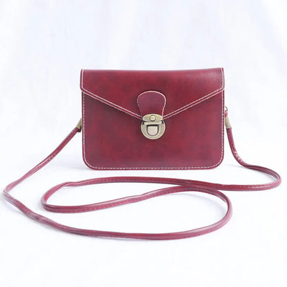 Retro shoulder messenger bag in cross square shape with flap and lock closure, showing internal mobile phone compartment