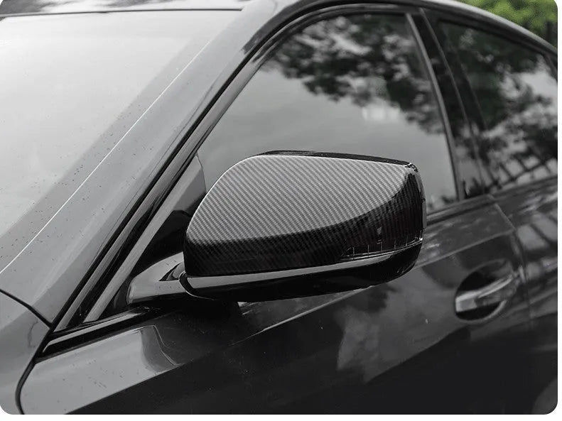 Pair of ABS plastic mirror covers for Cadillac CT5 CT6 in carbon fibre, silver, and rain frame finishes.