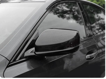 Pair of ABS plastic mirror covers for Cadillac CT5 CT6 in carbon fibre, silver, and rain frame finishes.