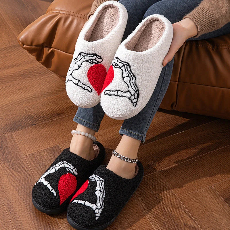 Halloween-themed skull-hand slippers in black and white, featuring non-slip soles for indoor comfort.