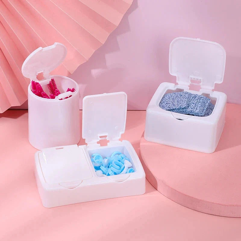 Three white plastic storage boxes for organising eyelash extension tools and accessories