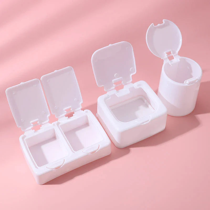 Three white plastic storage boxes for organising eyelash extension tools and accessories