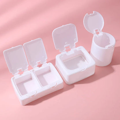 Three white plastic storage boxes for organising eyelash extension tools and accessories