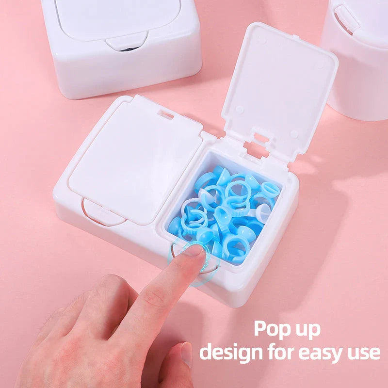 Three white plastic storage boxes for organising eyelash extension tools and accessories