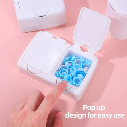 Three white plastic storage boxes for organising eyelash extension tools and accessories