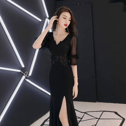 Elegant black evening dress with middle-length sleeves, perfect for formal occasions and red carpet events