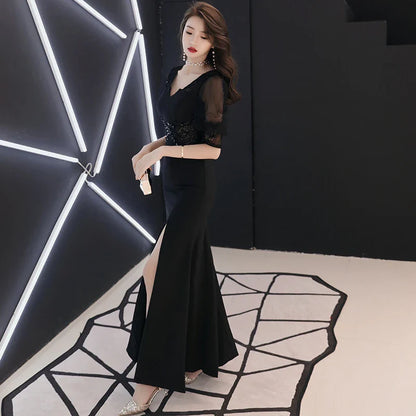 Elegant black evening dress with middle-length sleeves, perfect for formal occasions and red carpet events
