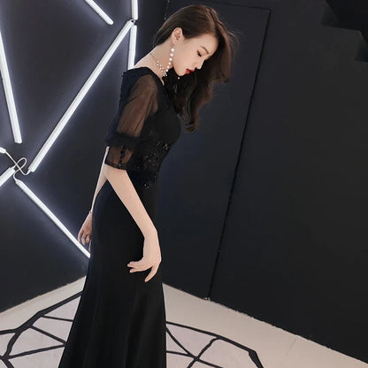 Elegant black evening dress with middle-length sleeves, perfect for formal occasions and red carpet events