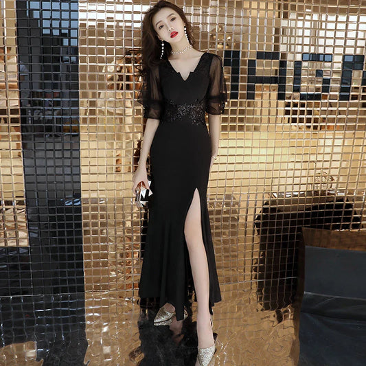 Elegant black evening dress with middle-length sleeves, perfect for formal occasions and red carpet events