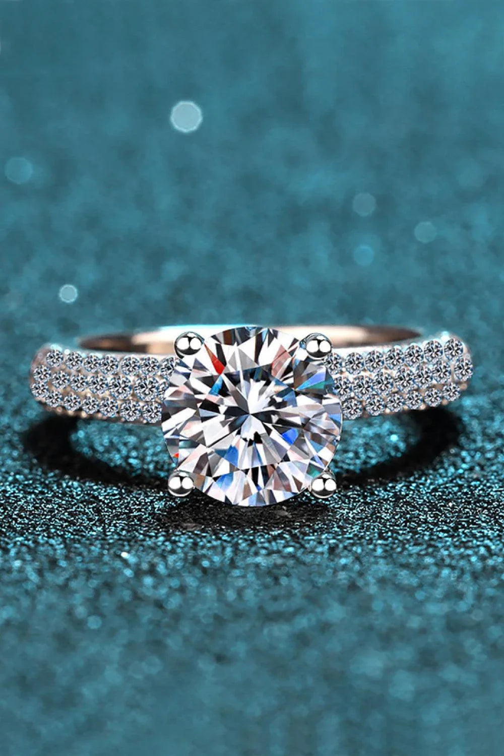 Elegant 4-prong moissanite and sterling silver ring with rhodium plating and zircon accent stones