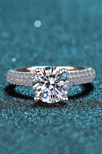 Elegant 4-prong moissanite and sterling silver ring with rhodium plating and zircon accent stones