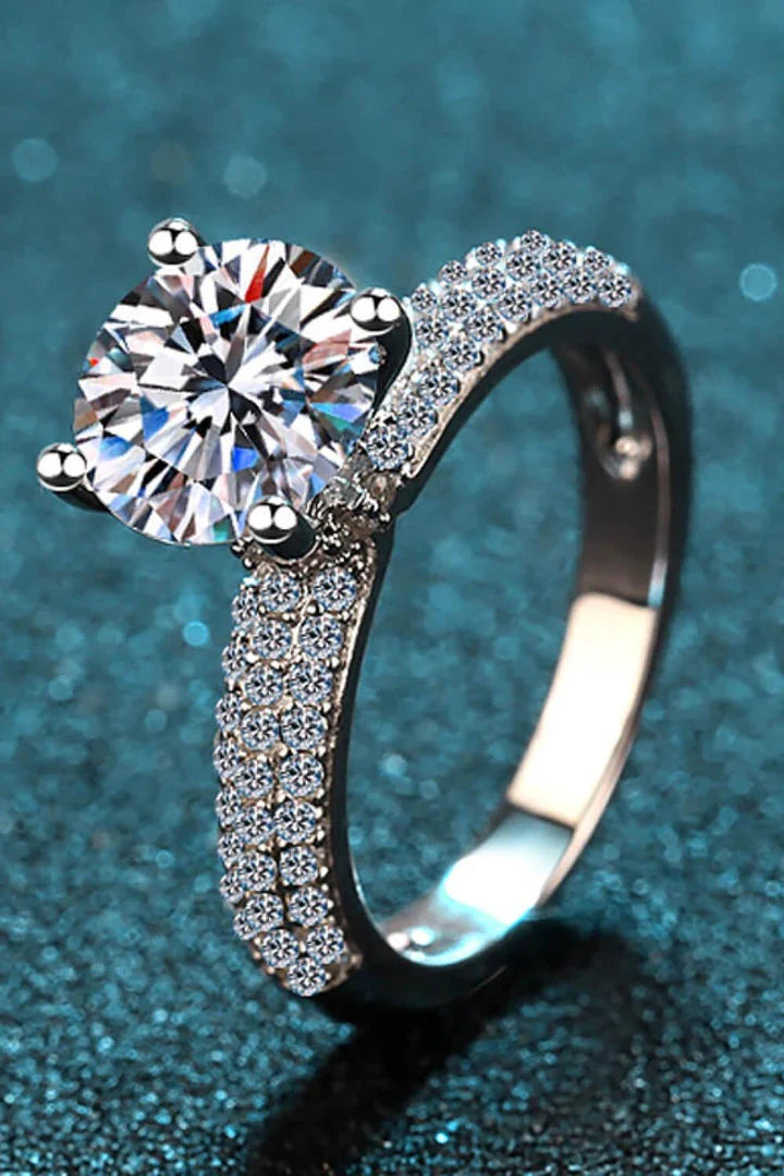 Elegant 4-prong moissanite and sterling silver ring with rhodium plating and zircon accent stones