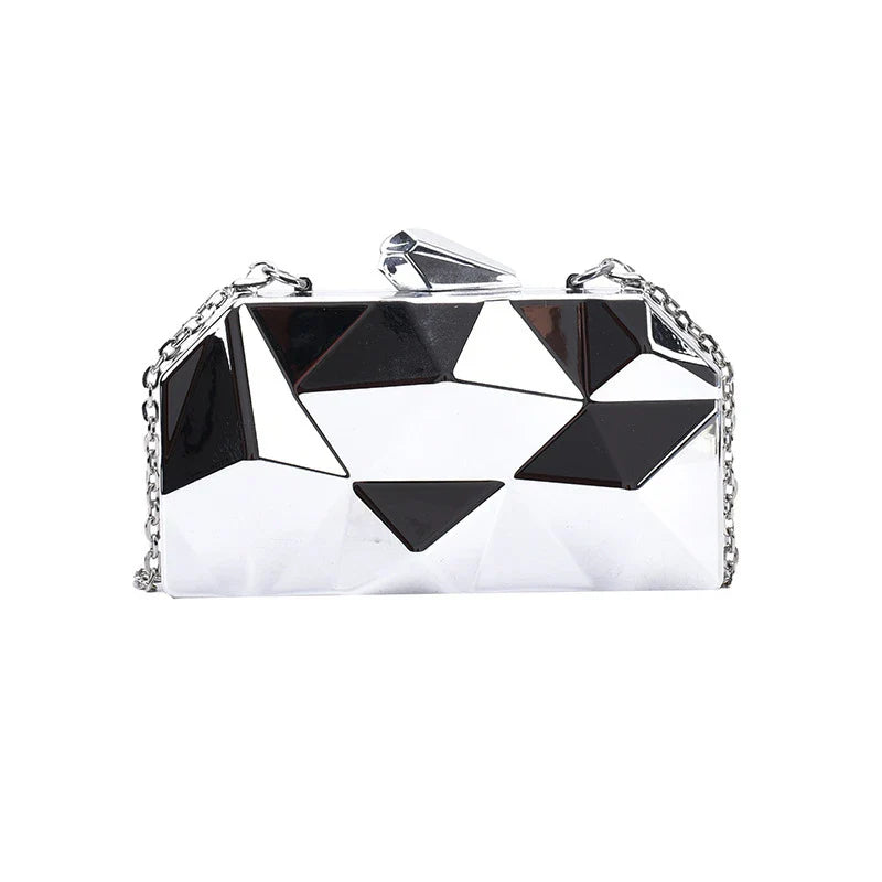 Elegant black leather handbag with a shimmering diamond-inspired chain strap, a timeless accessory for the modern British fashionista.