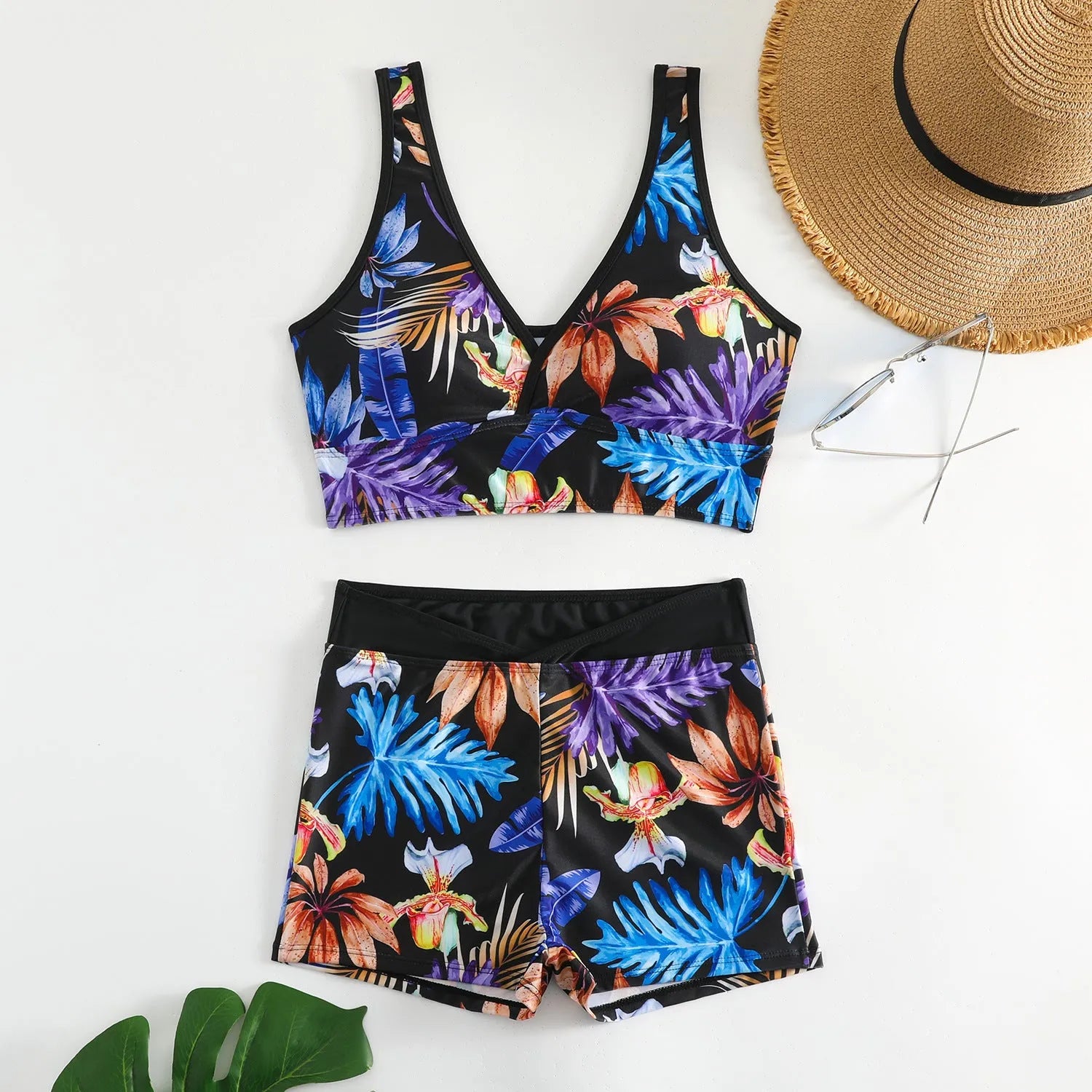 Women's two-piece swimsuit set showing sleeveless bikini top and printed boxer-style briefs in a multi-colour pattern.
