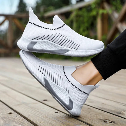 Men's black and white striped slip-on sneakers with lace-up front and mesh upper.