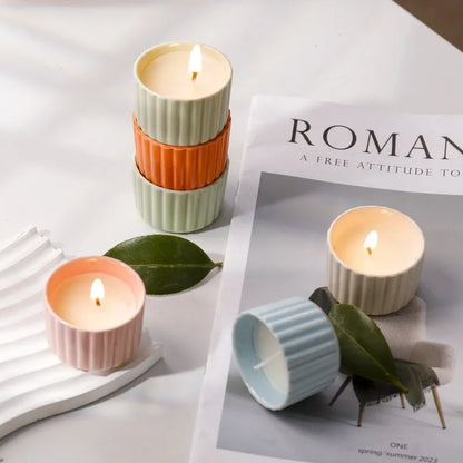 Soy wax aromatherapy candle inside a handmade ceramic cup, shown in a mint green colour.