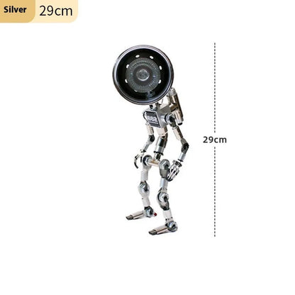 Silver copper robot-shaped decorative desk lamp with custom graphic option on a wooden shelf.