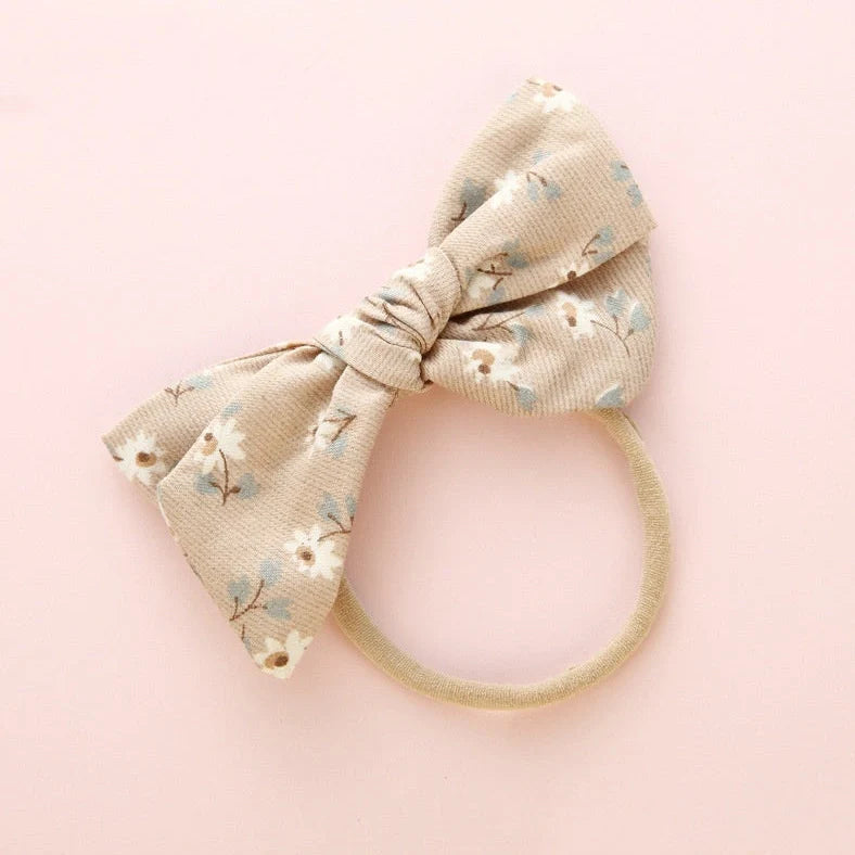 Children's cloth hair band with knotted bow design in one of six colour options