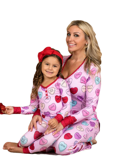 Adorable heart-printed family pajamas with long-sleeve tops and full-length bottoms in a range of sizes for children and adults.