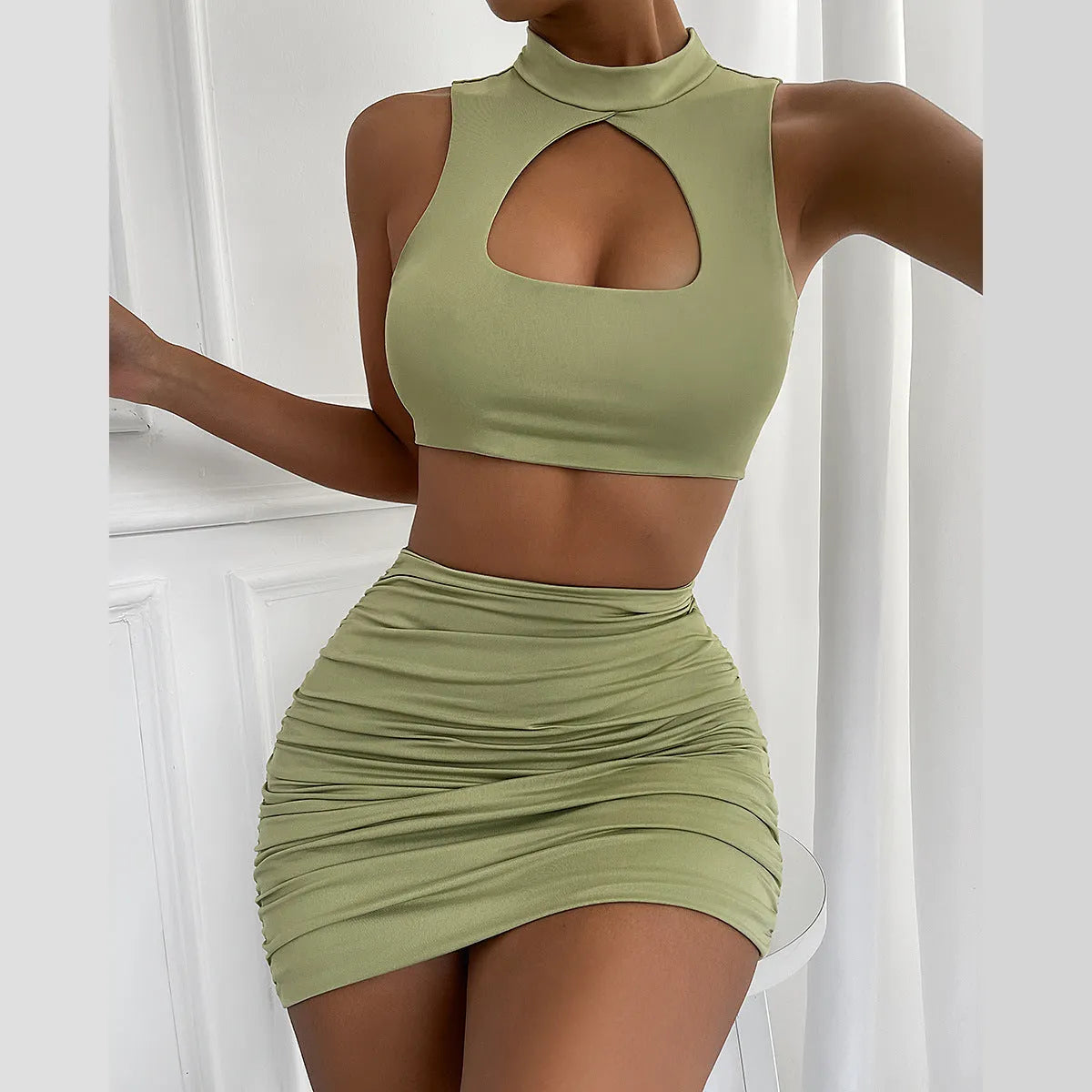 Light purple women's hollow vest and matching split skirt two-piece set on a model.