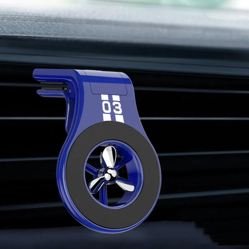 Black magnetic car phone holder attached to air vent with phone mounted and fragrance slice visible