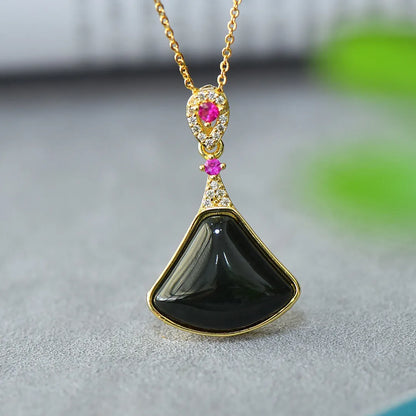 Copper inlaid pendant with natural grey Hetian jade and dark ink blue jade on a necklace.