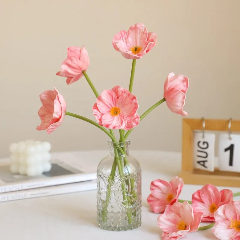 Pack of 15 mini artificial poppy flowers in assorted colours including purple, pink, yellow and red.