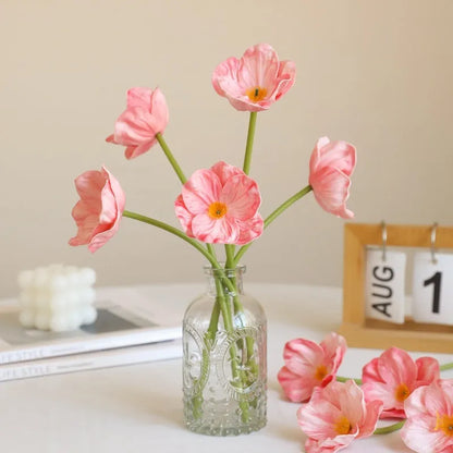 Pack of 15 mini artificial poppy flowers in assorted colours including purple, pink, yellow and red.