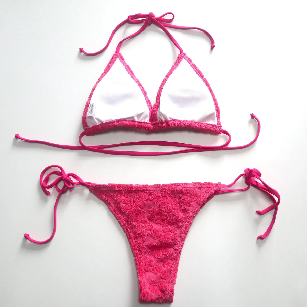 Women's bikini swimsuit with three-point lace-up detail in blue or rose red.