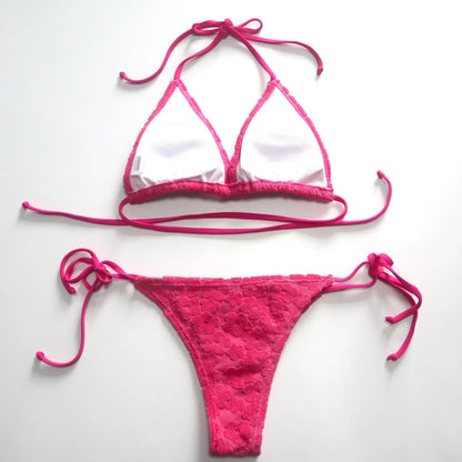 Women's bikini swimsuit with three-point lace-up detail in blue or rose red.