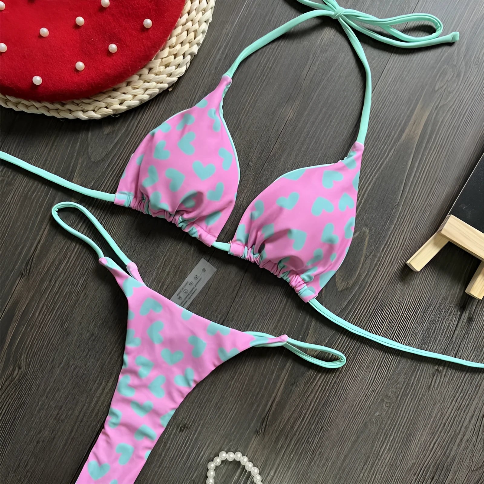 Heart print women's backless one-piece swimsuit with split sides on a mannequin