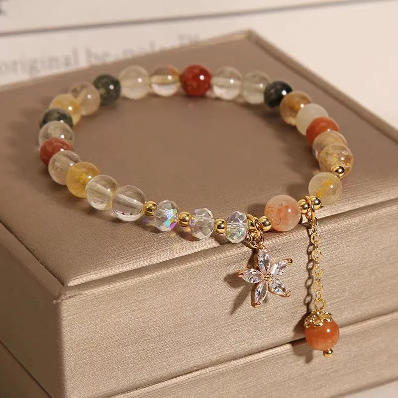 Colourful hair crystal stretch bracelet with cat's paw, butterfly, flower, and purse charms on adjustable band