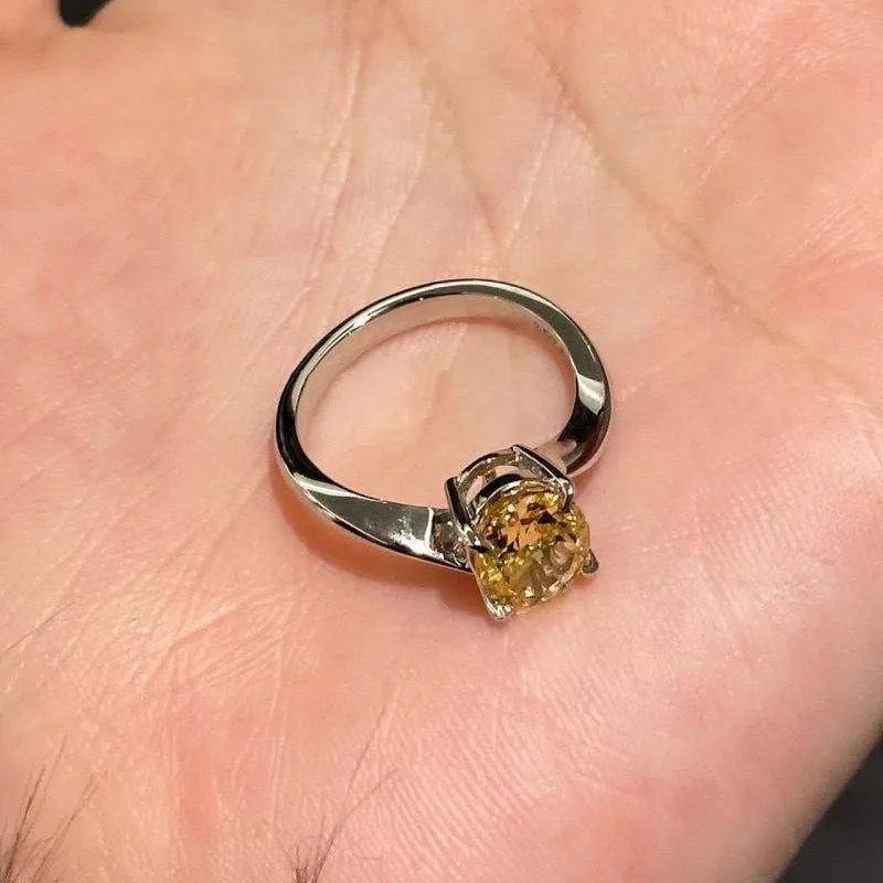 Women's yellow rock sugar crystal copper fashion ring on a hand.
