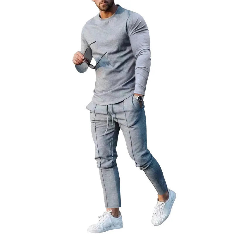 Men's solid colour two-piece lounge suit with long sleeve T-shirt and trousers in light grey.